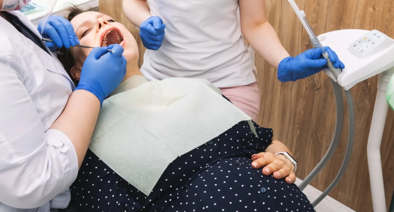 Pregnant woman consulting dentist for safe dental care during pregnancy
