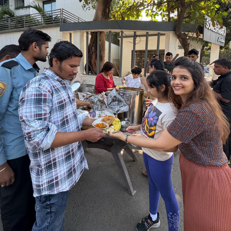 Volunteers serving food at Smile Invent Dental Clinic CSR event