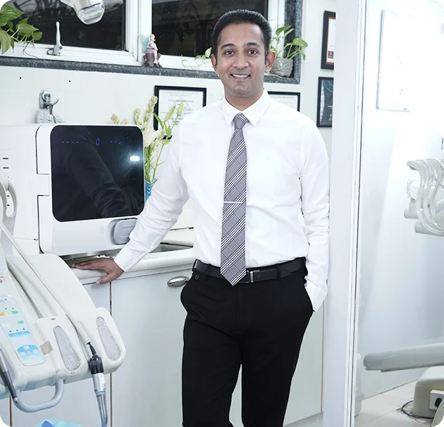 Dr. Arjun Panikar, Periodontist and Oral Implantologist, at Smile Invent Dental Clinic